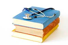 Books stacked with a stethoscope on top.